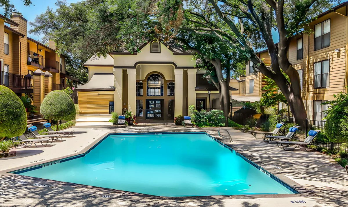 The community pool at Regal Court Apartments, surrounded by apartment buildings and mature trees.